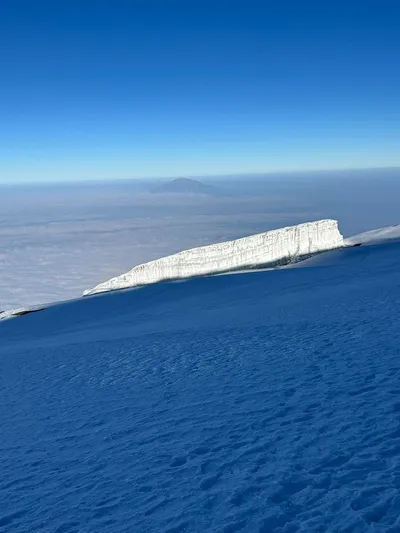 Massive ice wall at the summit plateau of Mount Kilimanjaro under a clear blue sky