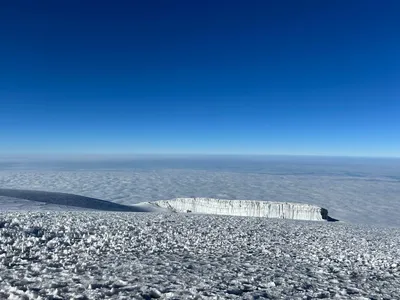 Stunning glacier formation near the summit of Mount Kilimanjaro overlooking a sea of clouds